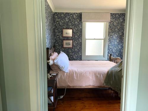 a person laying on a bed in a bedroom at The Reverie - a place to rest in Kyneton