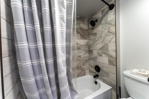 a bathroom with a shower curtain next to a tub at Wild Irishman #1030 by Summit County Mountain Retreats in Keystone