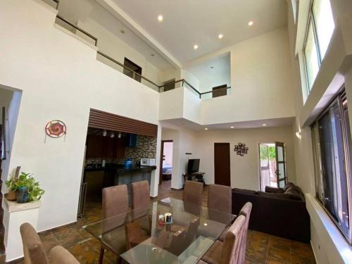 a living room with a glass table and a couch at Casa Escondida in Isla Mujeres