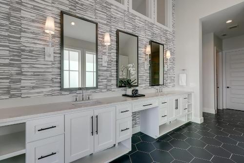 a bathroom with two sinks and two mirrors at Keepin' It Reel 234 LAK in Port Aransas