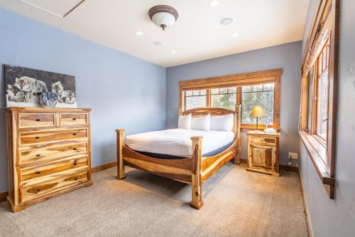 a bedroom with a bed and a dresser and a window at 671 Elk Circle by Summit County Mountain Retreats in Keystone