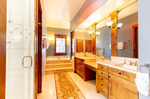 a large bathroom with two sinks and a shower at 671 Elk Circle by Summit County Mountain Retreats in Keystone