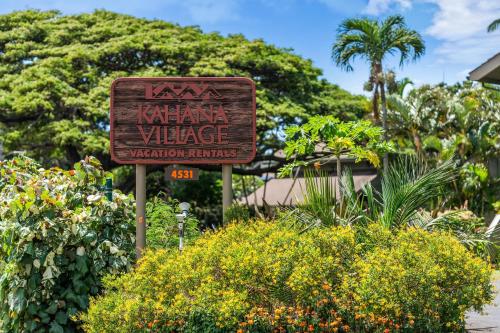 a sign for the kaharma village in a garden at Kahana Village 33 · KHV 33 Oceanfront 2BD Villa Spectacular Ocea in Kahana