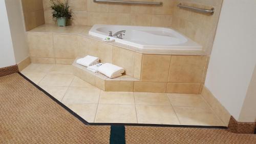 a bathroom with a sink and towels on a tiled floor at Oceanfront Lodge in Crescent City