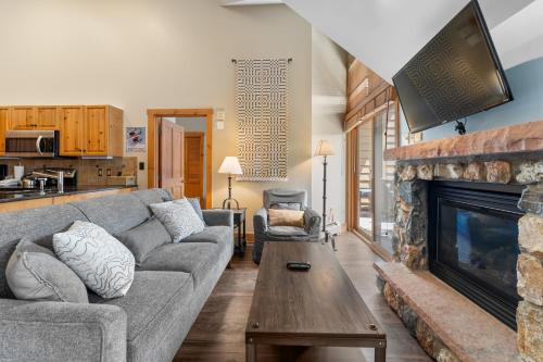 a living room with a couch and a fireplace at Expedition 8631 in Keystone