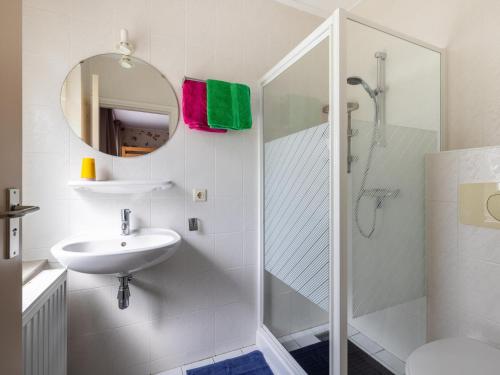 a white bathroom with a sink and a shower at Zonnehoek in Exloo