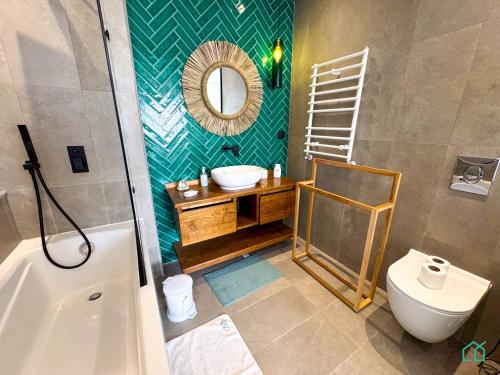 a bathroom with a sink and a mirror and a toilet at The Penthouse Gammarth in Gammarth