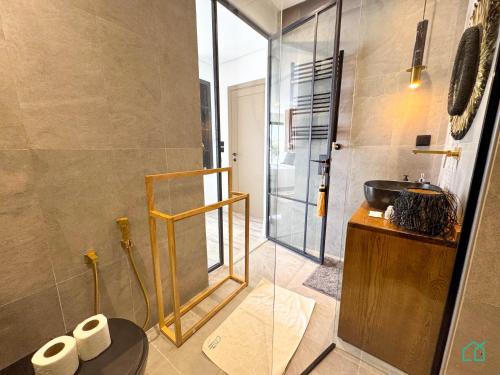 a bathroom with a glass shower and a sink at The Penthouse Gammarth in Gammarth