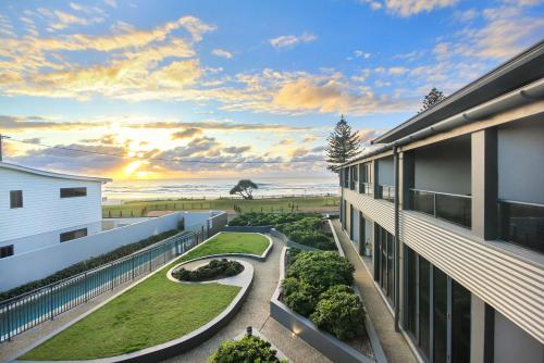 a view of the ocean from the balcony of a building at Lennox Holiday Apartments in Lennox Head