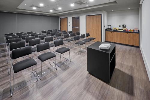a conference room with a row of chairs and a podium at City Express by Marriott Tijuana Insurgentes in Tijuana