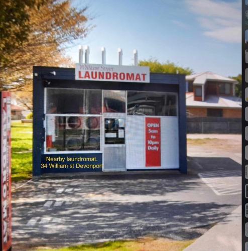 a garage with a sign on the side of it at Strawberry fields in Devonport