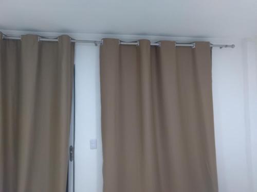 a curtain in a room with at Pousada mirante por do sol in Niterói
