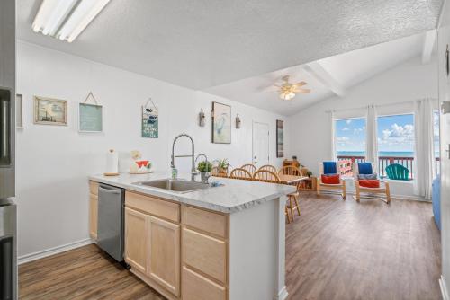 a kitchen with a sink and a living room at Oceanfront 4BR, Peaceful, Cozy, Kids/Pet Friendly! in Freeport