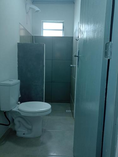 a bathroom with a toilet and a shower at New hotel in Alegrete