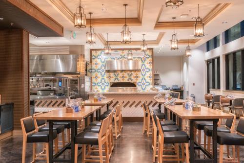 a dining room with wooden tables and chairs at Delta Hotels by Marriott Grand Okanagan Resort in Kelowna