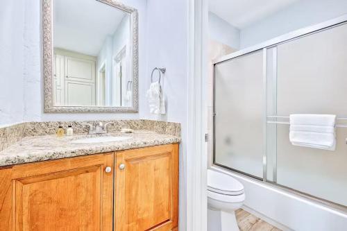 a bathroom with a toilet and a sink and a shower at Oceanfront Condo in Newport Beach with Private Balcony and Perfect Location by the Pier in Newport Beach