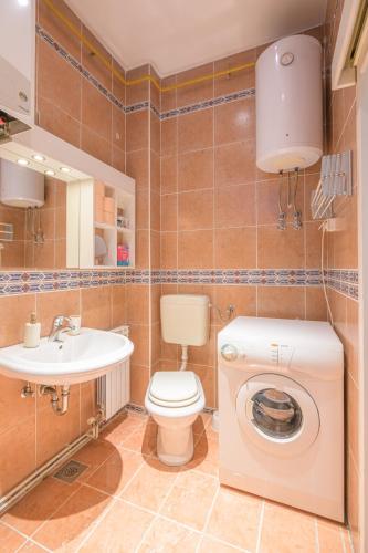 a bathroom with a toilet and a sink at STUDIO APARTMENT SiLVER in Sarajevo