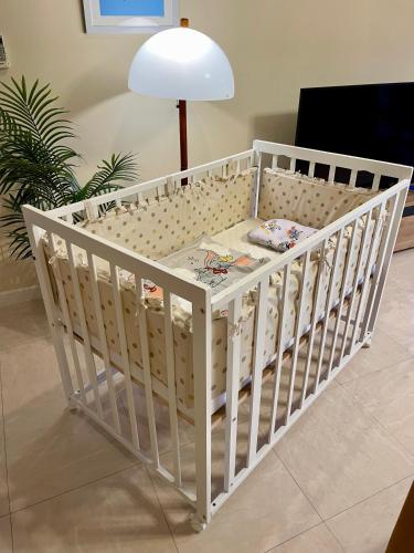 a white crib in a room with a lamp at  M’sOceanⅡ Uruma in Uruma