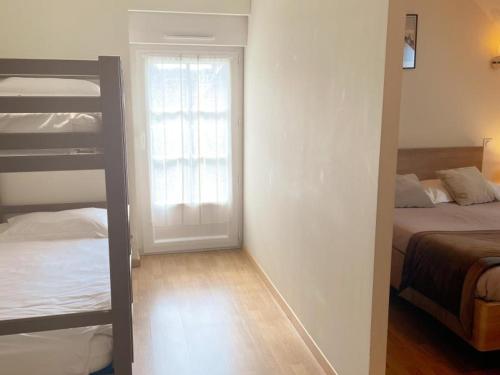 a small room with two bunk beds and a door at Gîte en Val de Loire: confort, jardin, parking et WiFi inclus - FR-1-491-452 in Thésée