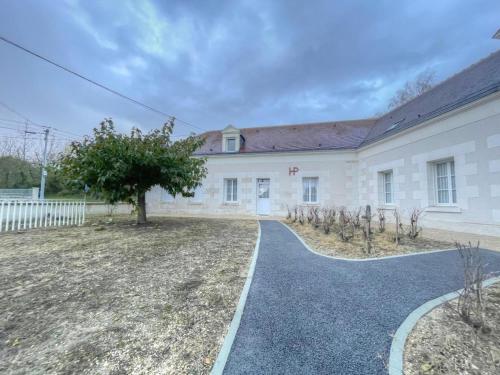a large white building with a tree in the yard at Gîte élégant avec climatisation, jardin et Wi-Fi près des Châteaux et Zoo de Beauval - FR-1-491-453 in Thésée