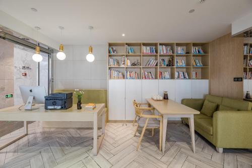 a living room with two tables and a couch at Atour Hotel Hangzhou Binjiang Jiangling Road in Hangzhou