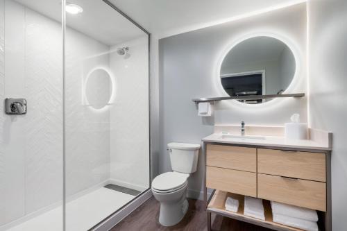 a bathroom with a shower and a toilet and a sink at TownePlace Suites by Marriott Brunswick in Brunswick