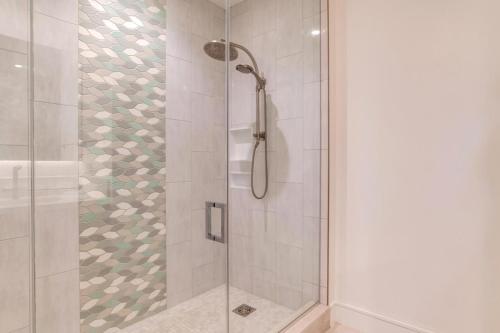 a shower with a glass door in a bathroom at Honua Kai Luana Condos by KBM Resorts in Kaanapali