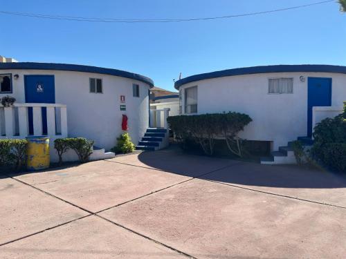 two white houses with blue doors and a driveway at Rosarito By The Sea in Rosarito
