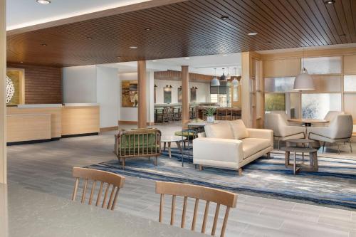 a lobby of a hotel with chairs and tables at Fairfield Inn & Suites by Marriott Boise West in Boise