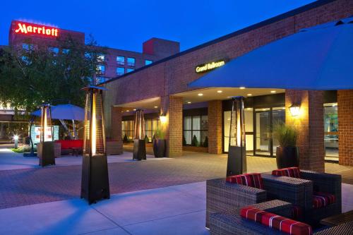 a lobby of a building with chairs and an umbrella at Boston Marriott Burlington in Burlington
