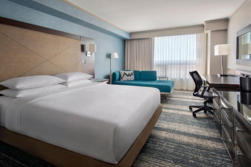 a hotel room with a large bed and a desk at Boston Marriott Burlington in Burlington