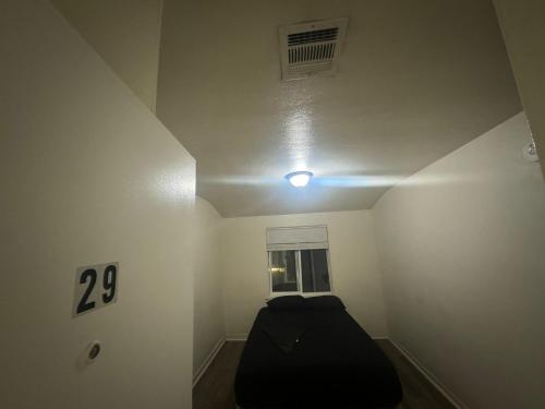 a room with a black bed in a room with a window at Van Nuys Homes for the Soul in Los Angeles