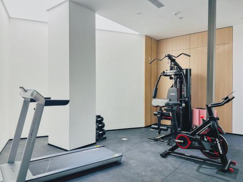 a gym with two exercise bikes and a treadmill at Dayin Garden Hotel -People's Square & Nanjing Road-Large Social Area -Bar -Café -Gym -Free Laundry Luggage Storage -24H Front Desk-English Service in Shanghai