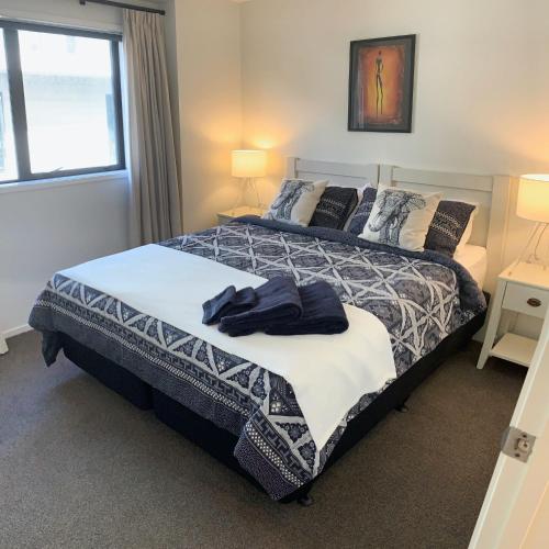 a bedroom with a large bed and a window at Hidden City House - short walk to everything in Auckland