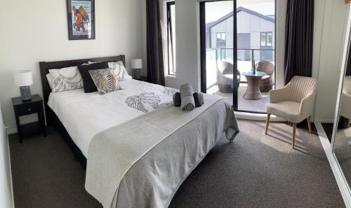 a bedroom with a bed with a teddy bear on it at Hidden City House - short walk to everything in Auckland