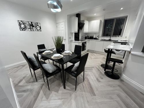 a kitchen and dining room with a table and chairs at Lymer House in Wolverhampton