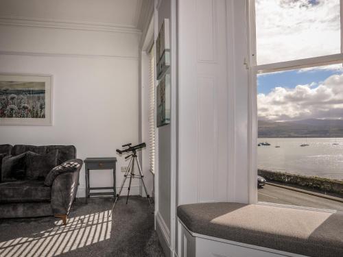 a living room with a view of the water at Lluest in Beaumaris