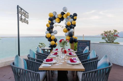 a table with food and balloons on a patio at Grand Hyams Hotel - Quy Nhon Beach in Quy Nhon