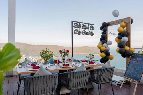 a table with chairs and a view of the ocean at Grand Hyams Hotel - Quy Nhon Beach in Quy Nhon