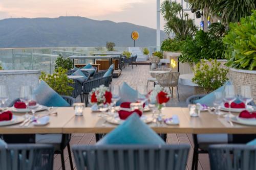 a group of tables and chairs on a patio at Grand Hyams Hotel - Quy Nhon Beach in Quy Nhon