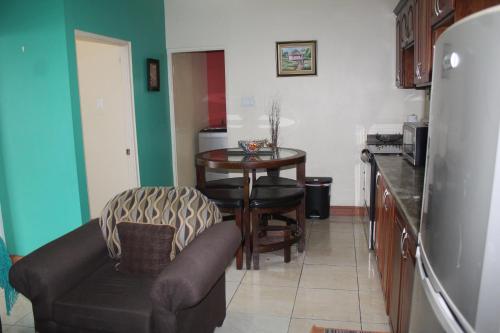a living room with a table and a couch at Cozy Deluxe 2BR Kensington New Kingston in Kingston