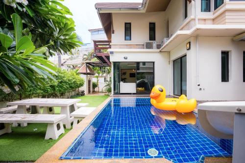 a pool with rubber ducky in the middle of a house at Amazing Natcha villa in Pattaya