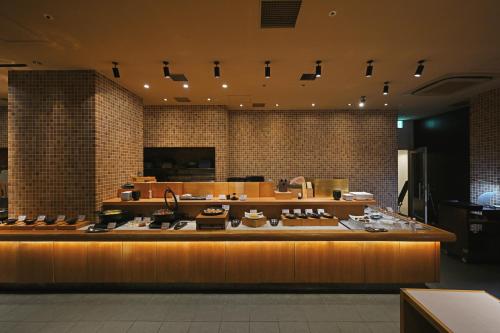 a store with a counter with many items on it at Prince Smart Inn Osaka Yodoyabashi in Osaka