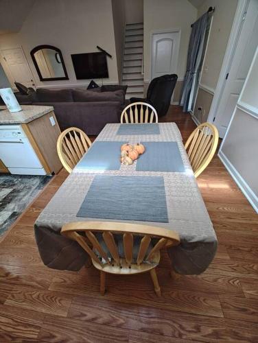 a table and chairs in a living room at Workers Love It Here! 3 Bedroom House with screened in porch in New Bern