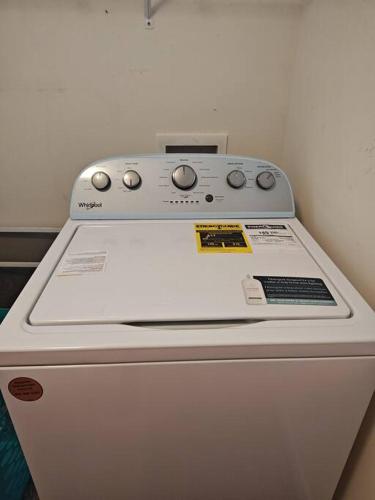 a washing machine sitting on top of a refrigerator at Workers Love It Here! 3 Bedroom House with screened in porch in New Bern