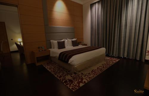 a hotel room with a bed and a window at The Umrao in New Delhi