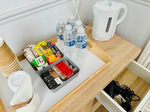 a table with bottled water and drinks on it at Le Papillon Hotel Blackpool in Blackpool