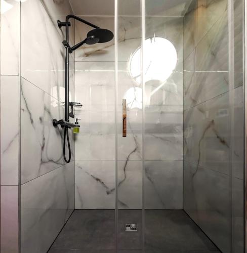 a bathroom with a shower with a glass door at Villa Wisdome in Farád