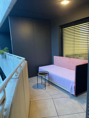 a small room with a bed and a table at Miracle in Bratislava