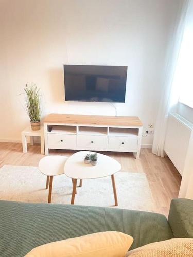 a living room with a tv and a couch and a table at TONY - 2 Zimmer mit Küche - Zentral in Memmingen
